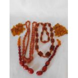 A part string of olive shape amber beads, the string terminating with glass beads, a polished