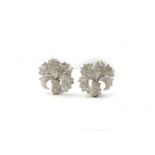 A pair of white metal and diamond floral cluster earrings, set with round-cut diamonds,