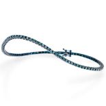 Frost of London. An 18ct white gold and blue rhodium plated blue diamond tennis bracelet, set with