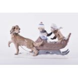 A large Lladro porcelain group of children in a sleigh, the two children seated in a sleigh being
