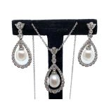 An 18ct white gold freshwater pearl and diamond pendant and earring set, total diamond weight in