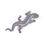 A silver gilt, diamond and emerald lizard brooch, the body with a line of diamonds down the spine,