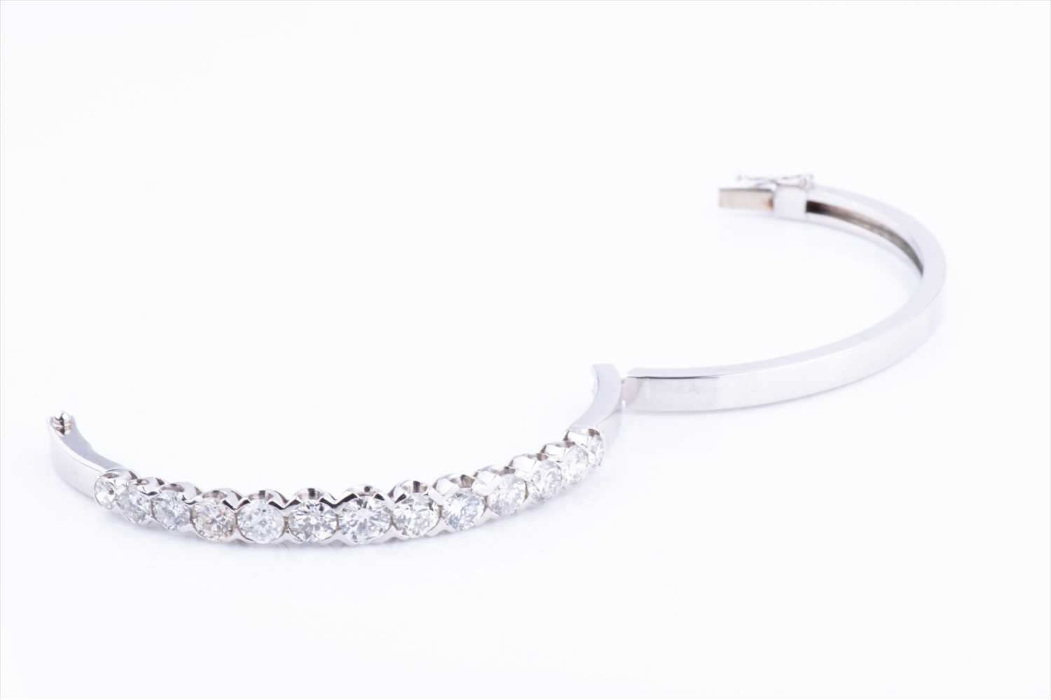 An 18ct white gold and diamond hinged bangle, set with thirteen round brilliant-cut graduated - Image 5 of 6