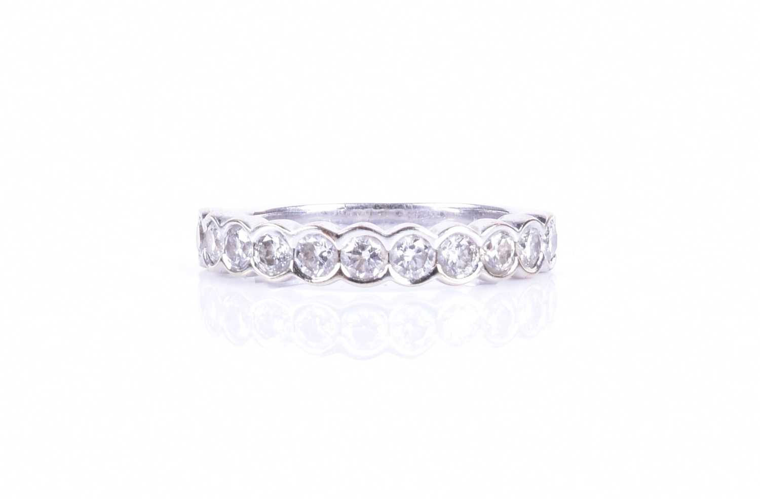 A diamond half-eternity ringbezel-set with eleven round brilliant-cut diamonds of approximately 1.10