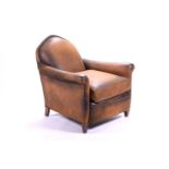 A tan leather club armchair with padded seat and curved armrests, with loose fitted cushion and