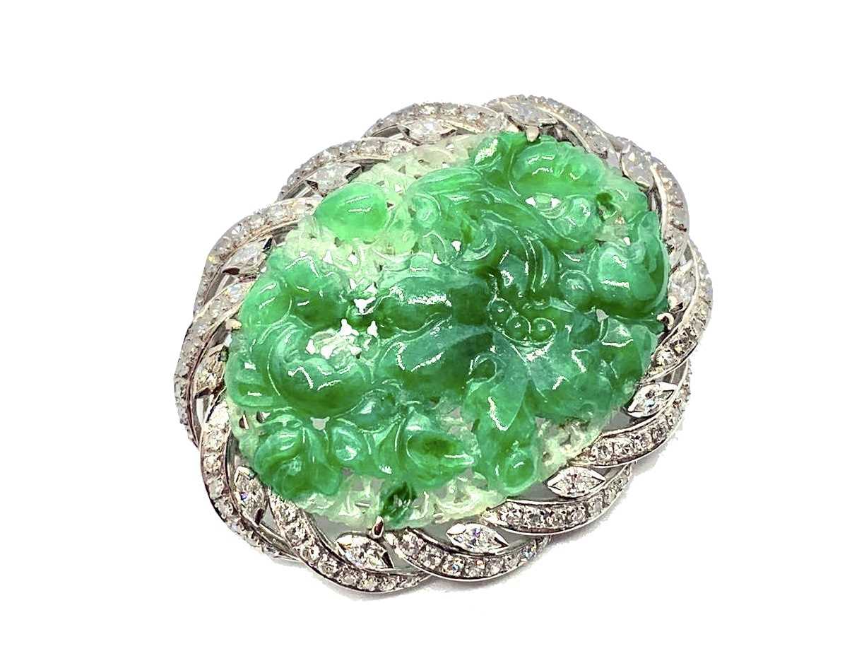 An 18ct white gold jade and diamond brooch, the central piece of carved jade surrounded by diamonds. - Image 3 of 4