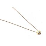 An 18ct yellow gold diamond pendant on a trace chain, set with rhodiumed rubover set brilliant cut