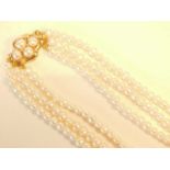 A three strand pearl choker necklace, with 14ct gold and pearl set clasp, the pearls approximately