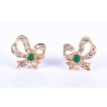 A pair of yellow metal, diamond and emerald metamorphic earrings, the ribbon-shaped mounts inset
