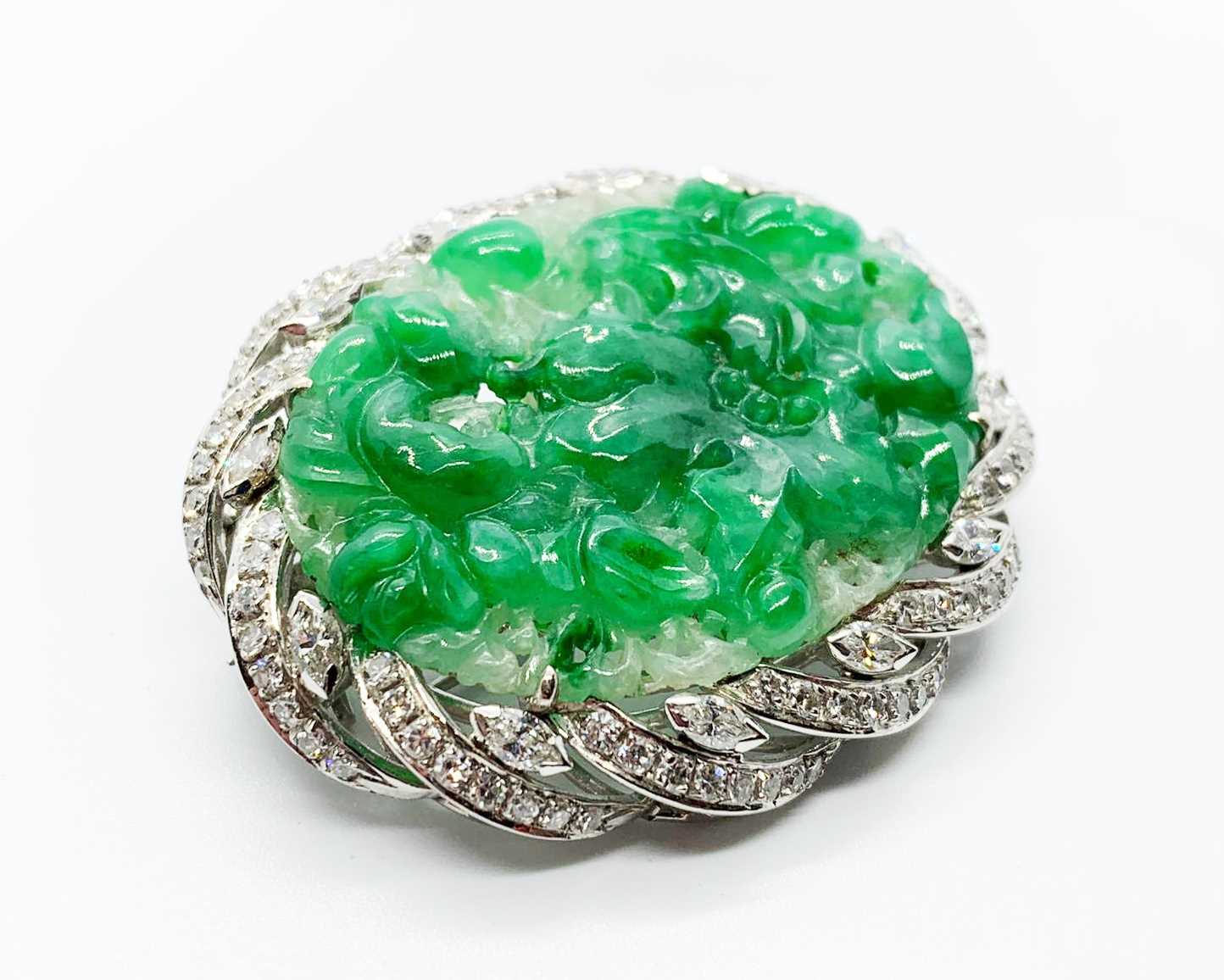 An 18ct white gold jade and diamond brooch, the central piece of carved jade surrounded by diamonds. - Image 2 of 4