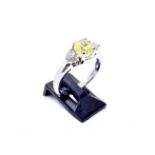 A platinum diamond ring, the central GIA certificated natural fancy intense greenish-yellow cut