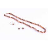 A light brown pearl necklace42 cm long, fastened with a yellow metal clasp stamped 14K, together
