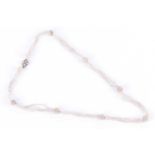 A late 19th / early 20th century seed pearl necklacecomprised of four-strand segments with rounded