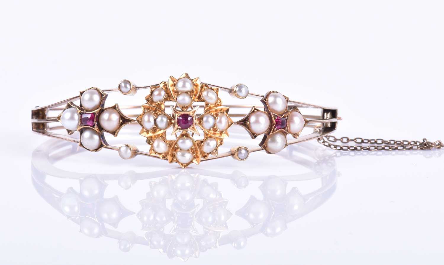 A Victorian 15ct yellow gold, pearl, and ruby banglethe hinged mount centred with a bright cut - Image 2 of 5