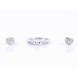 A white metal and diamond ringset with a round-cut diamond of approximately 0.15 carats, the