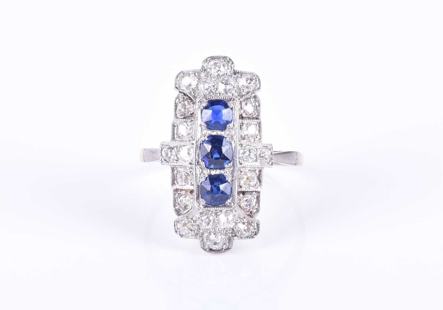 An Art Deco diamond and sapphire cocktail ringthe shaped rectangular panel mount centred north to