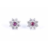 A pair of platinum, diamond, and ruby floral cluster earringseach centred with a round-cut ruby (the