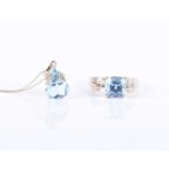 A 9ct yellow gold, diamond, and blue topaz ringset with a faceted cushion-cut blue topaz, the