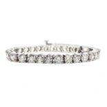 An 18ct white gold diamond tennis bracelet, brilliant cut diamonds of L/M colour and SI-P1 clarity