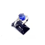 A platinum sapphire and diamond ring, the central oval sapphire of good colour weighing 2.25 carat