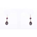 A pair of Victorian garnet and diamond drop earringseach with a round cabochon garnet above an old-