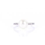 A Continental diamond and natural pearl ringset with a round white natural pearl of approximately