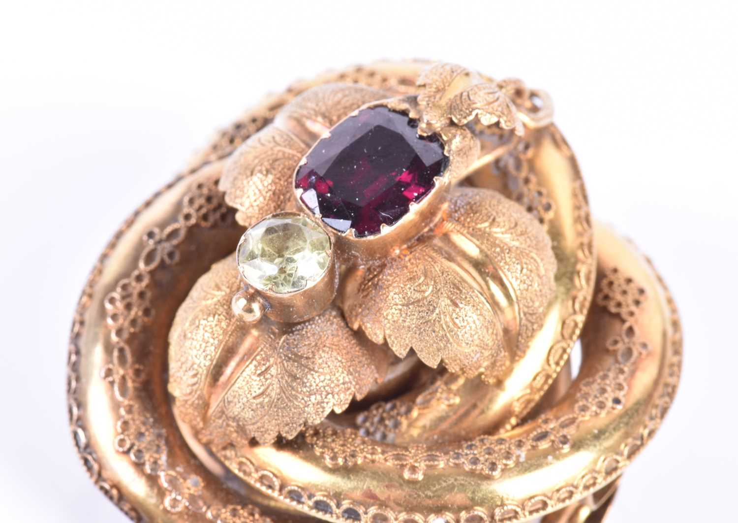 A Victorian yellow gold and garnet broochof knotted design, the mount with engraved decoration and - Image 3 of 6