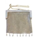 An early 20th century ladies white metal evening bag, the pierced frame engraved with flowers and