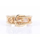 An 18ct yellow gold and diamond buckle ringthe mount pave-set with round-cut diamond accents, marked