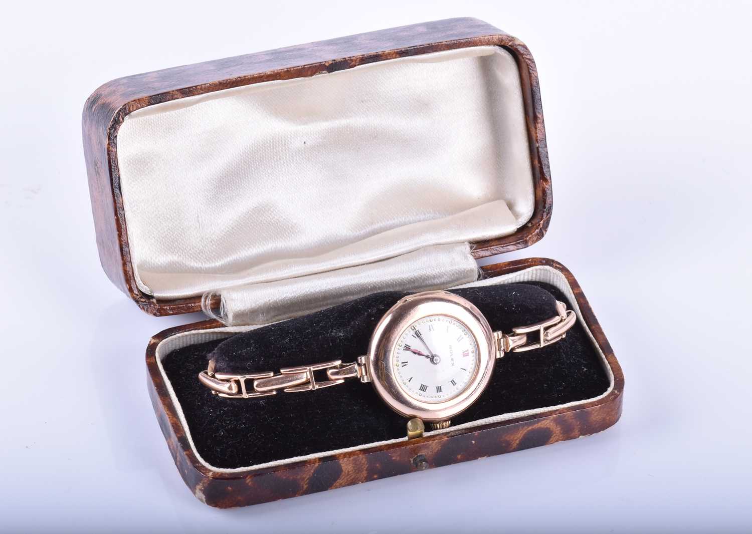 An early 20th century 9ct yellow gold ladies Rolexthe round gold bezel containing a white Roman