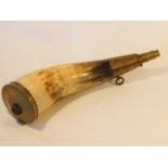 A 19th century brass mounted cow horn powder flask, the nozzle with ring turned decoration and