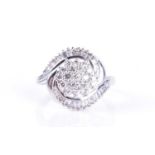 A white metal and diamond swirl cluster ringcentred with a cluster of round-cut diamonds, within a