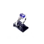 Hallmarked 18ct white gold tanzanite and diamond ring, the central oval tanzanite of good colour