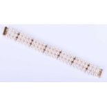 A triple strand pearl bracelet, the pearls with good lustre, approximately 7mm diameter, rows with