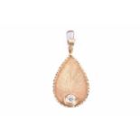 An 18ct yellow gold and diamond pendantof leaf design, inset with a round-cut diamond of