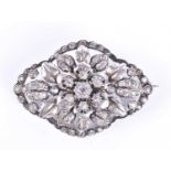 A Victorian silver and paste broochof floral design, with engraved leaves, and paste-set petals