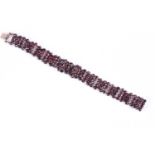 A 19th century rose-cut garnet braceletwith gilt metal articulated segments inset with clusters of