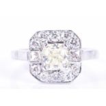 An 18ct white gold and diamond cluster ringcentred with a cushion-cut fancy yellow diamond of