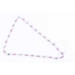 A platinum, diamond, pink tourmaline, and natural saltwater pearl necklace the fine chain