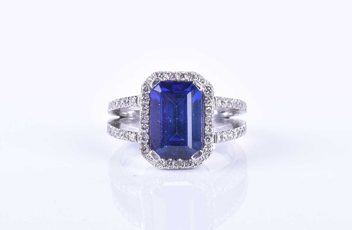 An 18ct white gold, diamond, and tanzanite ringset with an emerald-cut tanzanite, measuring