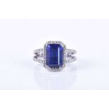 An 18ct white gold, diamond, and tanzanite ringset with an emerald-cut tanzanite, measuring