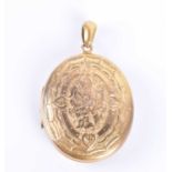 A Victorian gilt metal locketof oval form, with engraved foliate decoration to both sides, bearing