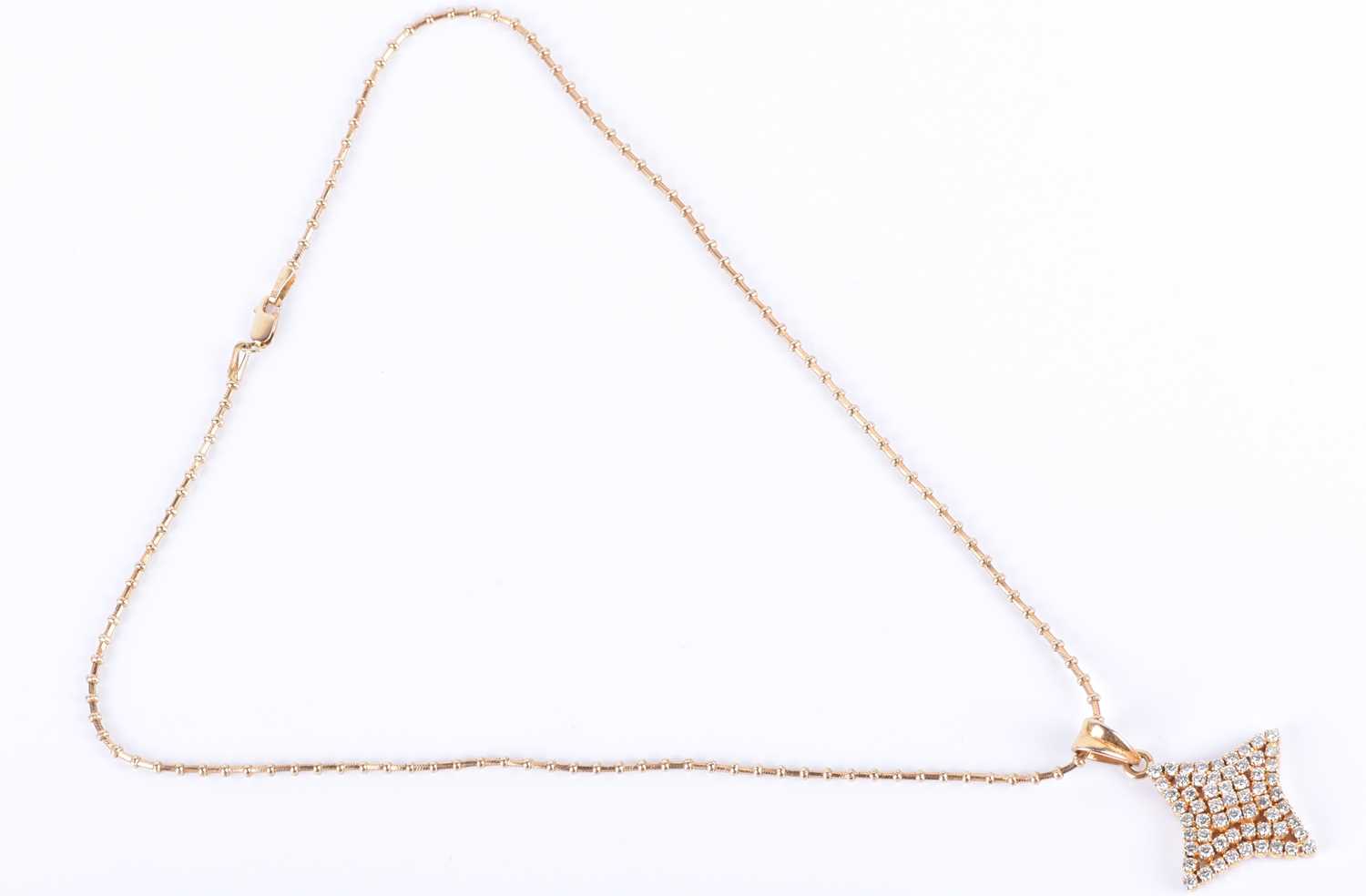 An 18ct yellow gold and diamond pendantin the shape of a four-pointed star, set with round