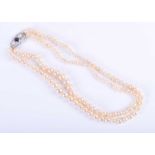 A double strand graduated cultured pearl necklace, strung with the larger pearls to the side,