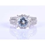 An 18ct white gold, diamond and aquamarine cluster ring, set with a mixed round-cut aquamarine