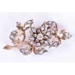 A diamond-set floral broochthe yellow metal and silver mount with stylised engraving to leaves,