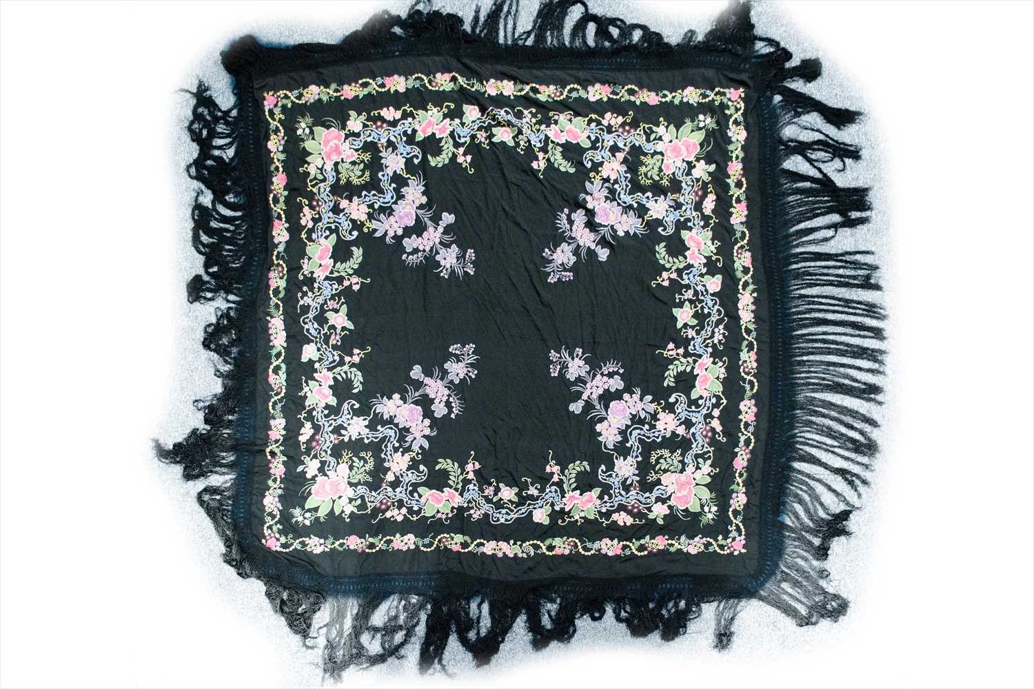 A black silk manton de Manila shawl, embroidered with roses and other floral decoration, with