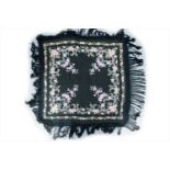 A black silk manton de Manila shawl, embroidered with roses and other floral decoration, with