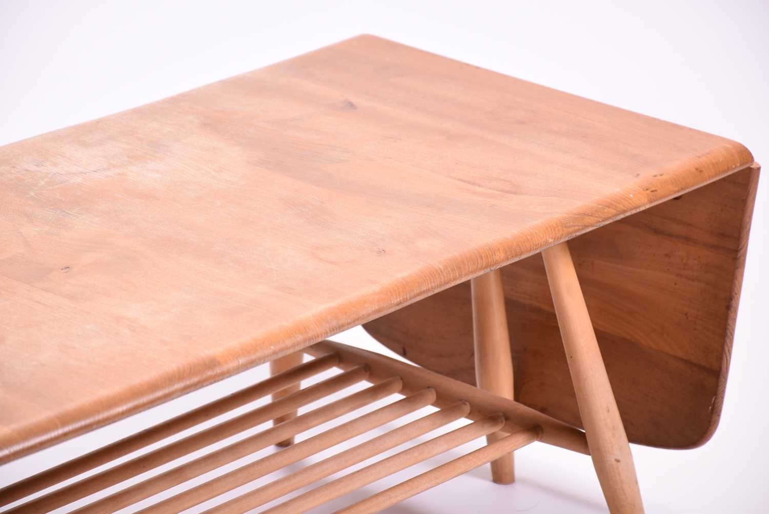 An Ercol extendable coffee table, with a pair of drop flaps and rack below. 108 cm wide, 46 cm deep, - Image 2 of 4