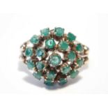 An 18ct rose gold emerald cluster ring, the shoulders each set with two beads, size M/NCondition